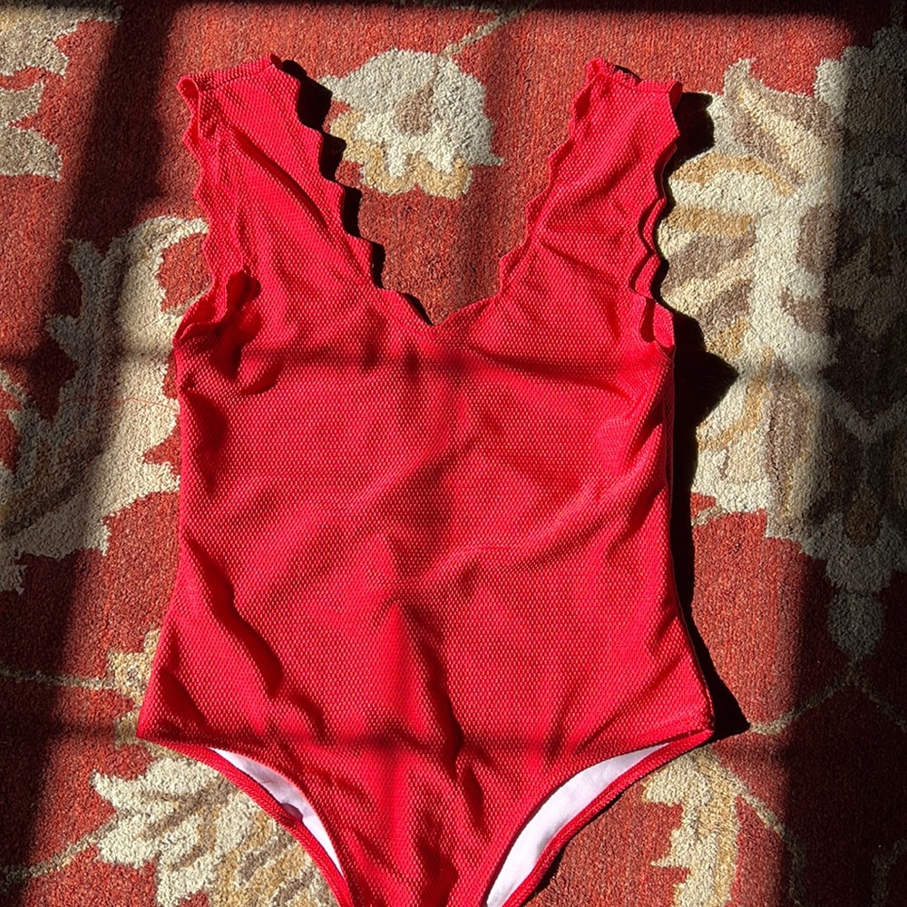 Size 12 one piece. Would make a cute bodysuit top also. Never worn!